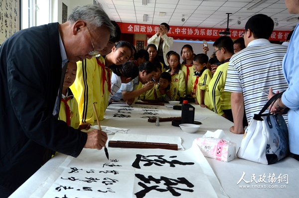 圖片說明： 書畫室委員與學(xué)生共同創(chuàng)作書法作品。